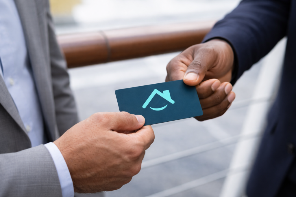 Two hands exchanging a business card